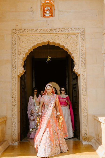 Bridal entry in coral lehenga on Anand Karaj