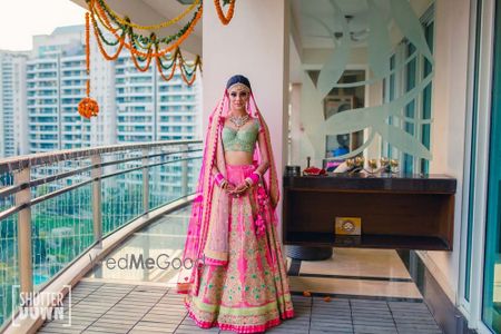 Photo of Mint and bright pink bridal lehenga