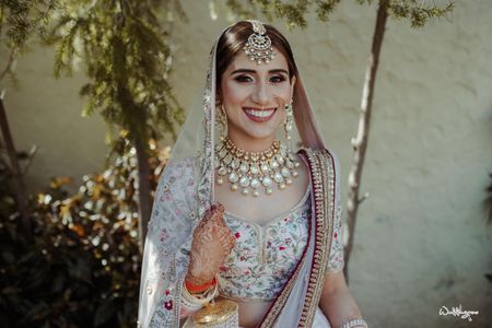 Photo of bridal jewellery with simple but statement maangtikka and necklace