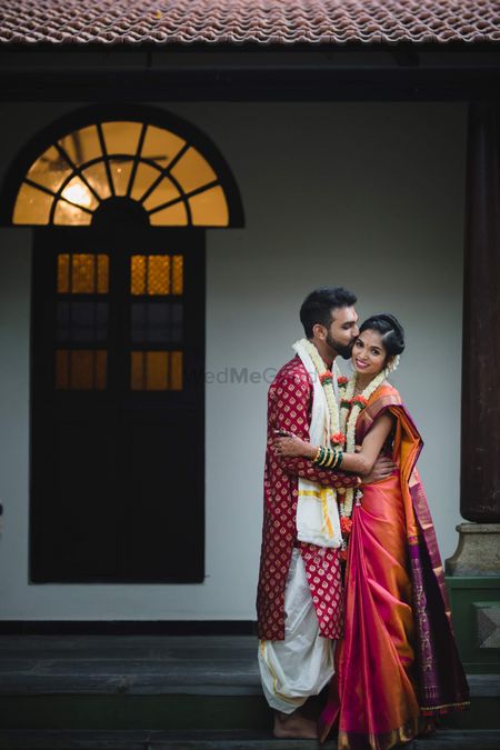 A color-coordinated south Indian couple on their wedding day