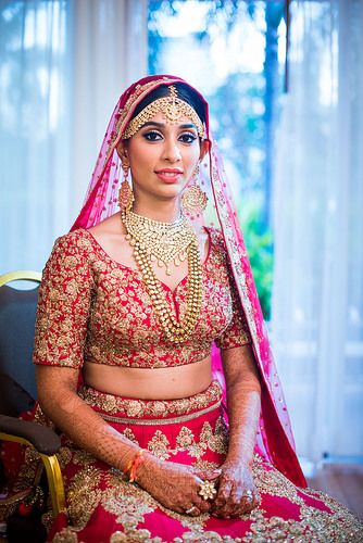 Bride in red with layered jewellery