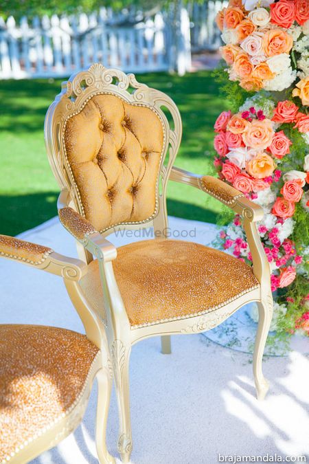 Gold cushion chair at mandap