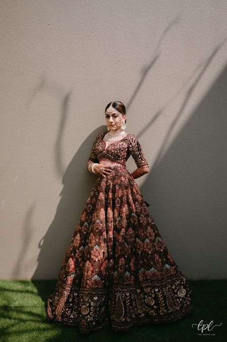 Stunning bridal lehenga shot in brown and peach hues and beautiful bridal jewellery