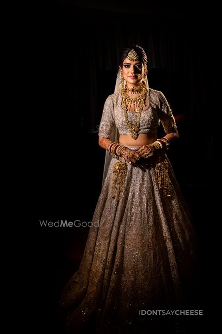 Bride dressed in a white lehenga.