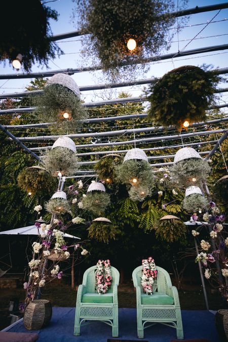 Unique mandap decor with suspended cane baskets