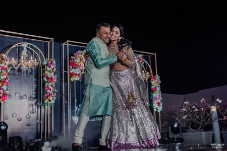 Happy bride and her father dancing at the Sangeet 