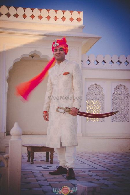 Photo of Tye dye safa on groom with white sherwani