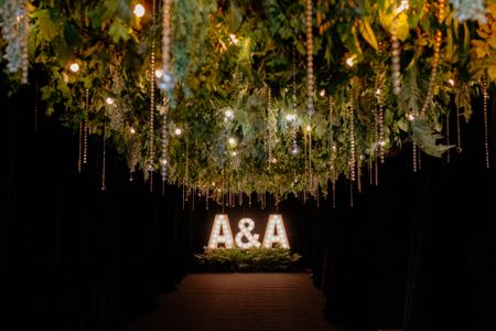 Fun giant LED letters in the couple's initials with hanging decor and lighting for the reception night