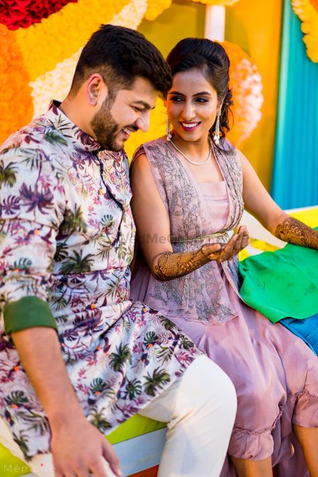 Photo of couple shot with offbeat mehendi outfit