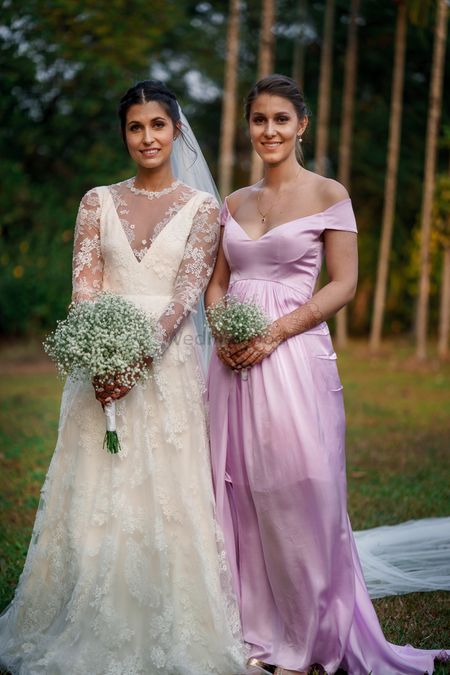 Photo of Bride with bridesmaid and babys breath bouquet