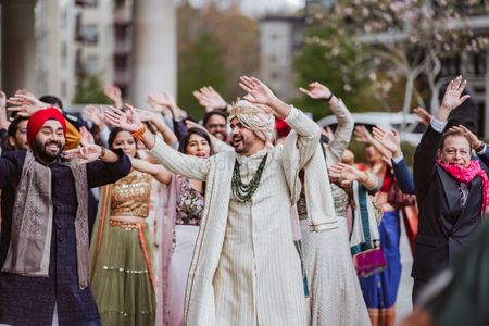 Photo of groom baraat entry idea with the whole family dancing