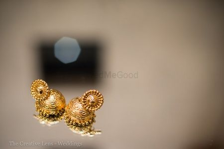 Photo of delicate gold jhumkis