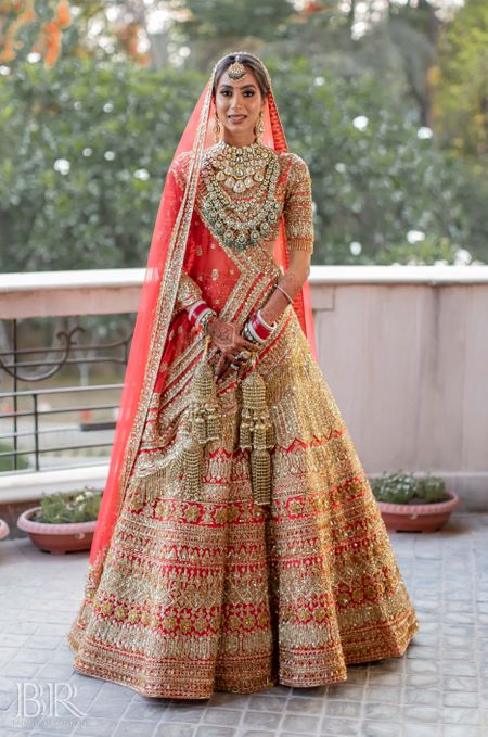Red and gold bridal lehenga heavy by Manish Malhotra