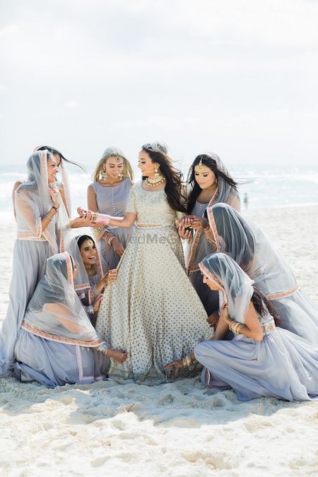 Photo of Bridesmaids in grey wearing dupattas on head