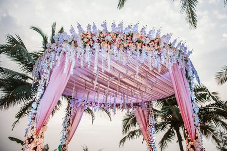 Circular mandap decor with florals and light pink fabric 