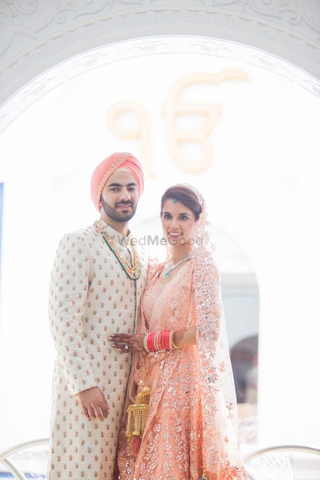 Photo of Bride and groom in peach matching