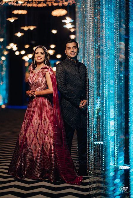 Bride and groom wearing stylish outfits for their sangeet.