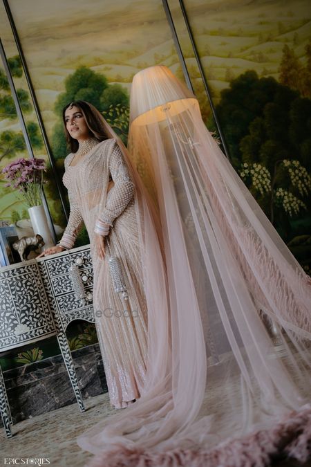Photo of Gorgeous nude and white saree with a full sleeves blouse for the wedding day with a statement veil.