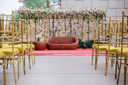 Photo of A simple and minimal decor arrangement with golden chair and flowers
