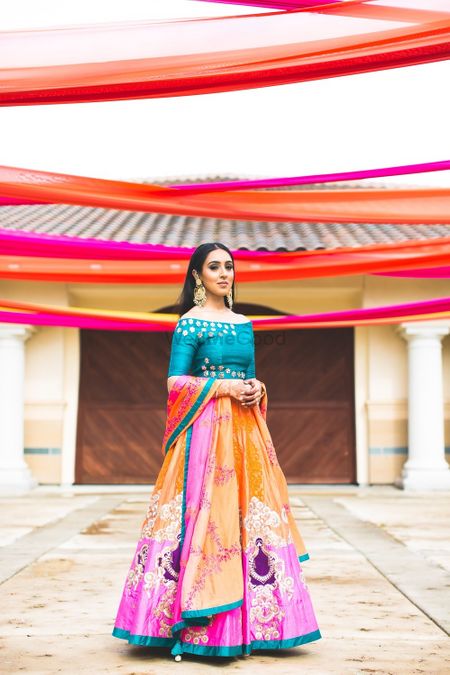 Quirky mehendi lehenga with teal off shoulder blouse