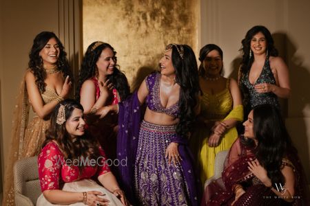 Fun shot of the bride with her bridesmaids on the sangeet night