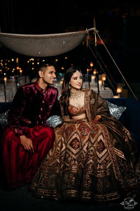 Photo of Bride and groom dressed in earthy hues for the sangeet.