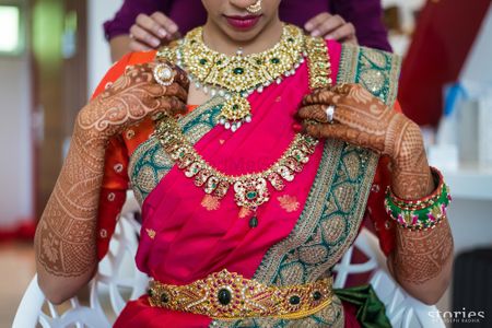 South Indian bridal jewellery with layered necklaces and waist belt 