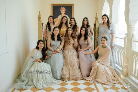 Photo of Fun group shot of the bride and her bridesmaids on the wedding day, all co-ordinated in pastel outfits