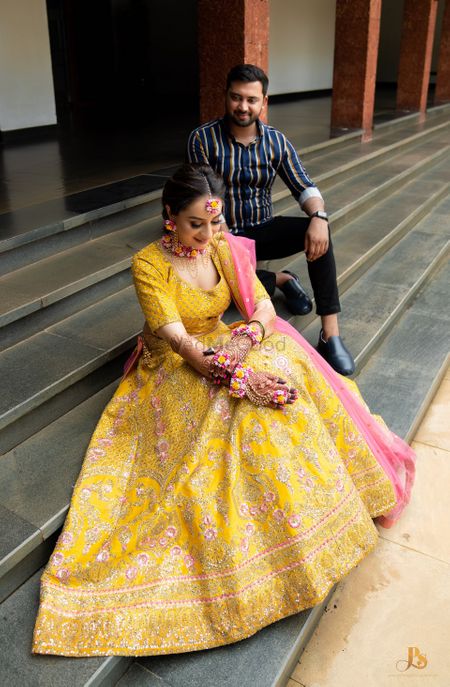 A candid shot of a bride and groom from their Mehendi ceremony.