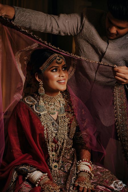 Photo of Bride under veil shot