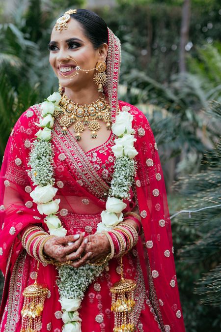 Bride in beautiful jewellery and red lehenga. 