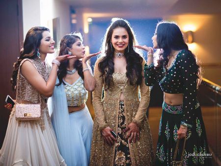 Pretty bride in golden and black anarkali with her bridesmaid 