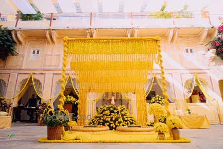 sunflower haldi seating decor idea with urlis