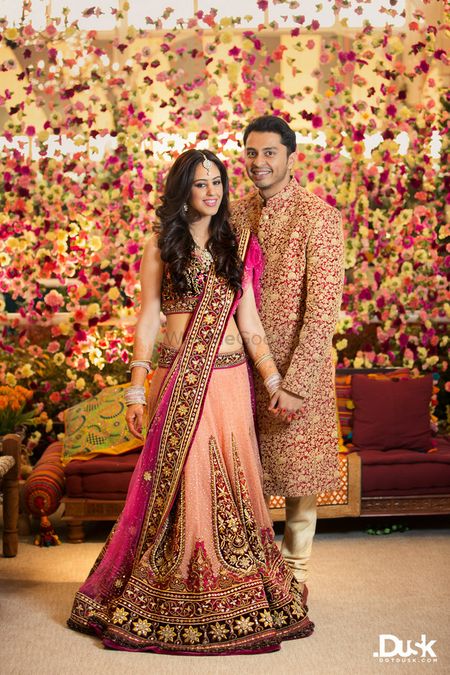 Floral backdrop with indian bride and groom