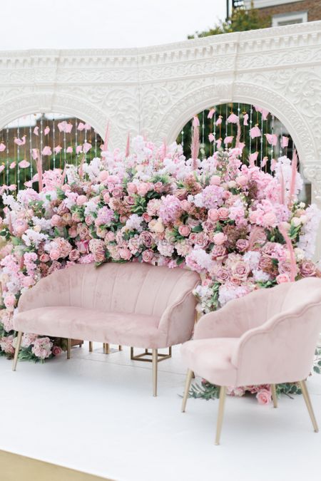pink floral backdrop with pink seating