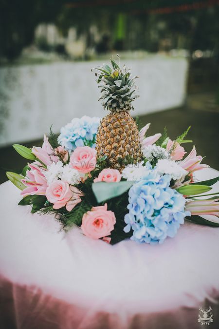 DIY centrepiece idea with pineapple and florals 