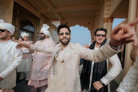 Photo of Fun capture of the groom dancing with his groomsmen as he enters with his baraaat
