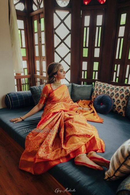 Lovely orange kanjeevaram pattu saree with gold jewellery for a modern bride look