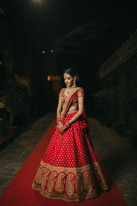 bride in classic red and gold sabyasachi lehenga