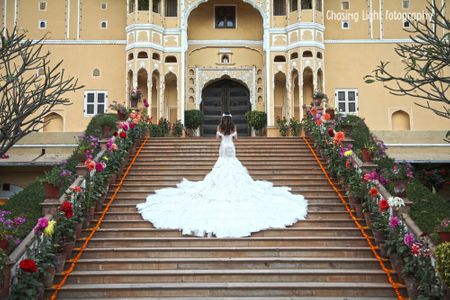 Bride in Ruffled White Wedding Gown with Dramatic Train
