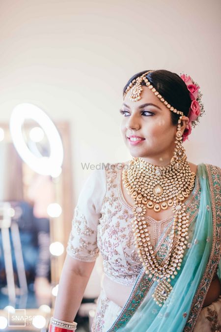 A happy bride in heavy gold jewellery. 