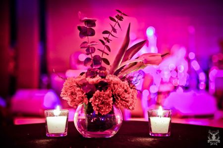 Photo of Table Centrepiece with Floral Arrangement and Candles
