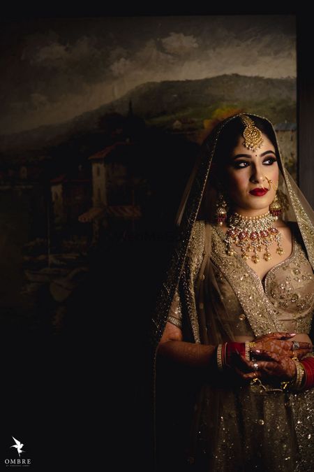 A bride in a gold lehenga for her wedding 