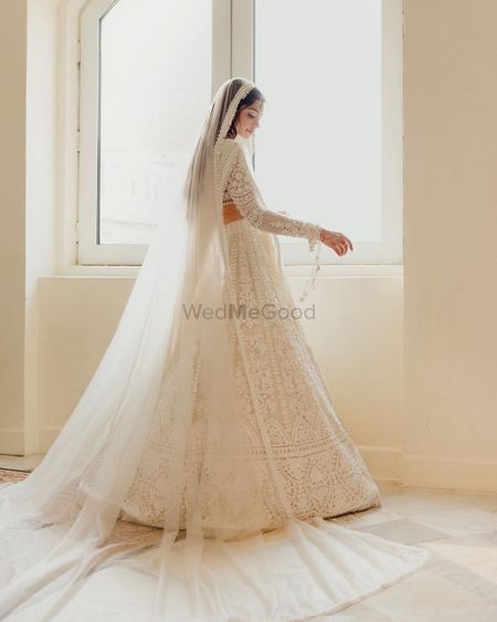 Photo of Alanna in white custom Manish Malhotra outfits on their wedding day
