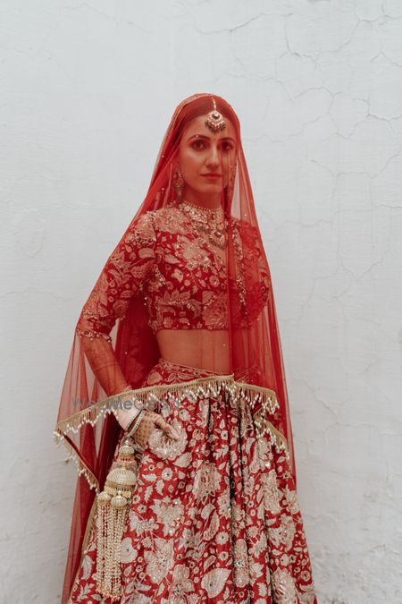 Stunning red and white bridal lehenga with the dupatta as a veil