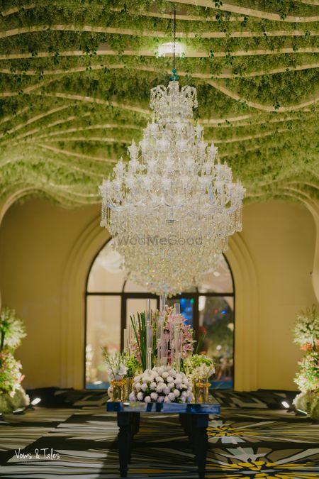 Breathtaking ceiling decor in green foliage with a statement glass chandelier
