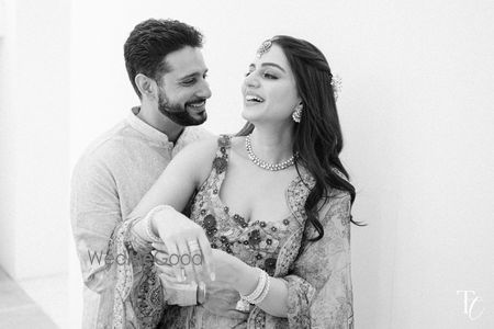 Photo of Lovely candid moment between the bride and groom in black and white