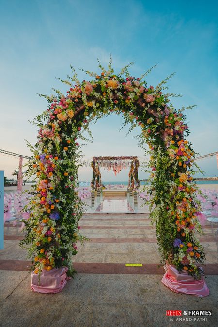 A floral archway decor with fresh flowers for a day wedding