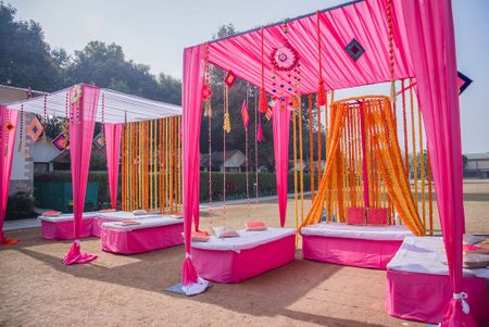Mehendi decor idea with seating with pink and orange theme