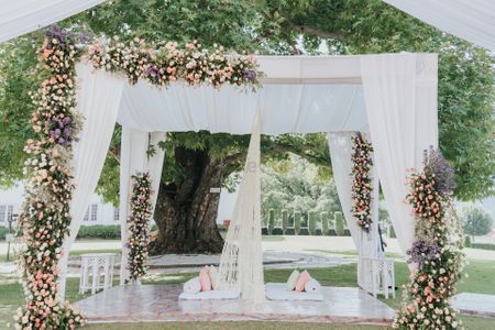 white outdoor nikah mandap with floral decor 